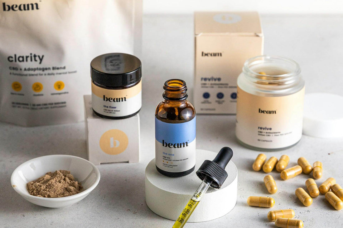 Collection of beauty products including clarity blend, revive moisturizer, and wellness capsules for skincare.