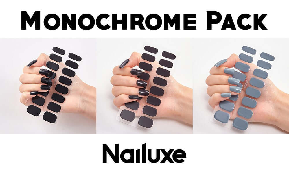 Monochrome Pack featuring Nailuxe nail stickers showcasing various shades of black and gray on manicured nails.