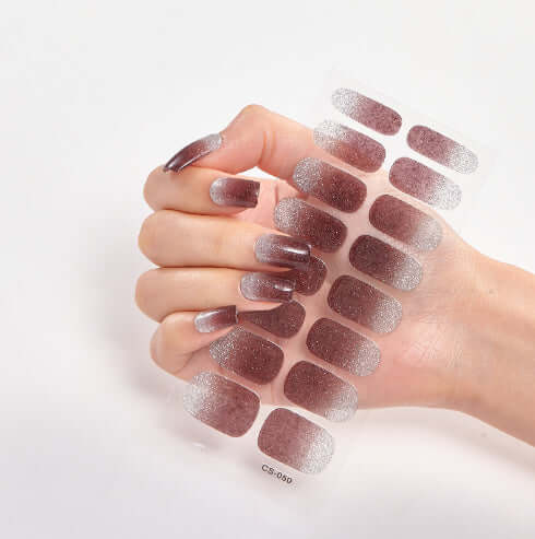 Hand displaying Pure Color 16 Nail Stickers in CS006 with shimmering rose gold finish.