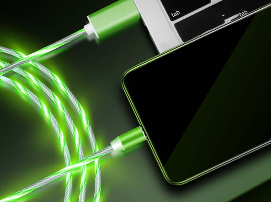 Magnetic streamer data line cable in green, connecting a smartphone to a laptop, showcasing fast charging capabilities.