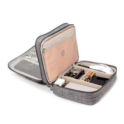 Open cable organizer bag displaying compartments for camera, chargers, and accessories in black and gray.