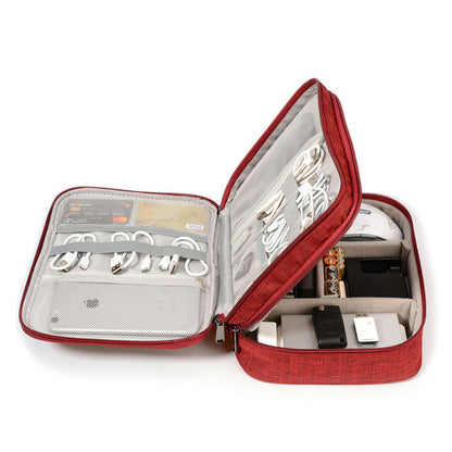 Red cable organizer bag open with electronic accessories: chargers, cables, and devices neatly stored inside.