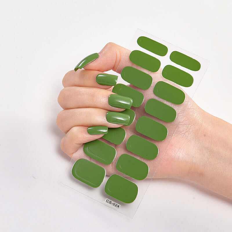 Elegant green Pure Color 16 Nail Stickers displayed on a hand, showcasing various nail designs for stylish manicures.