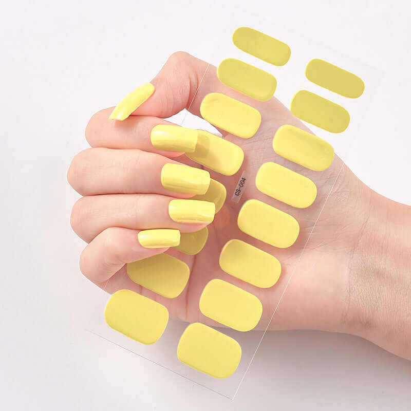 Bright yellow Pure Color nail stickers on a hand, showcasing 16 different shapes for nail art.