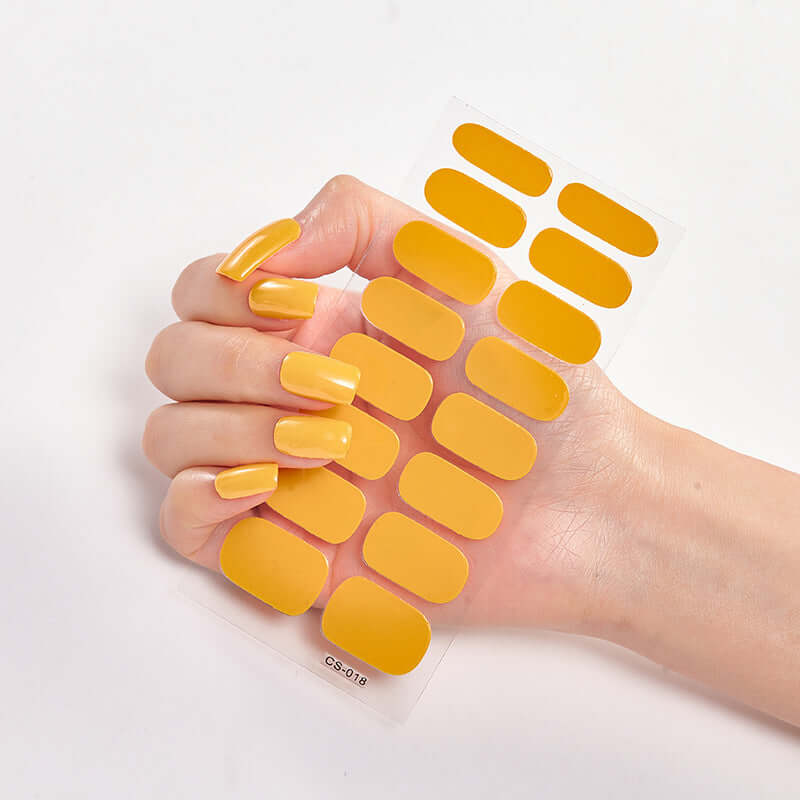 Pure Color 16 Nail Stickers featuring vibrant yellow shades on a hand with manicured nails.