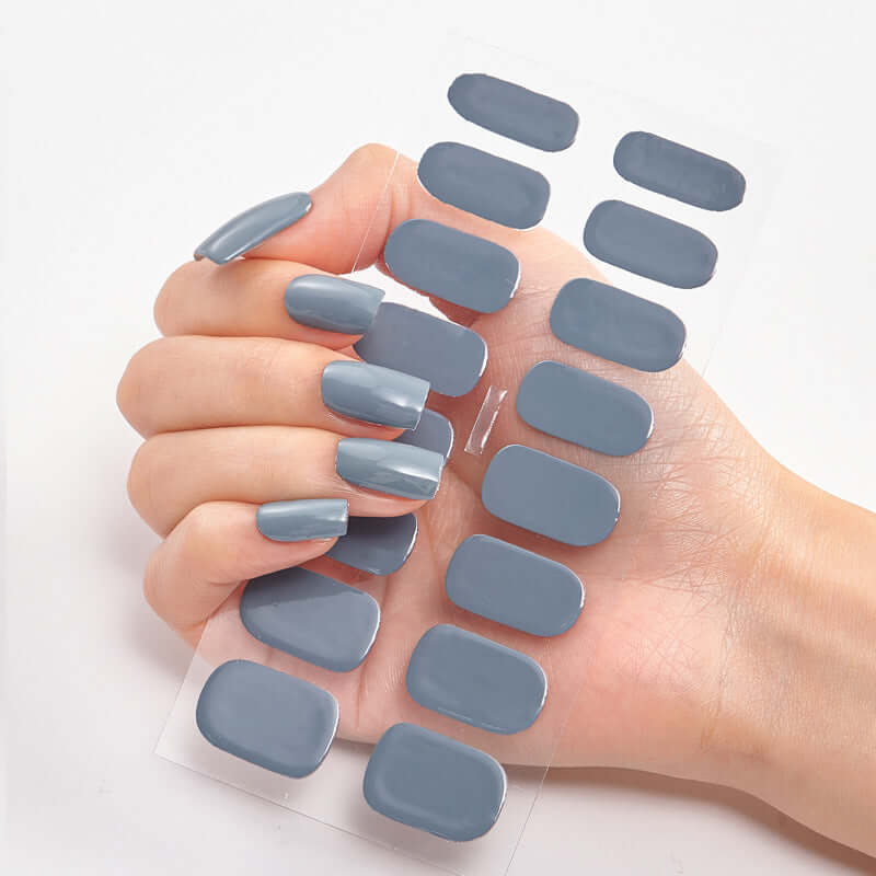 Hand holding gray Pure Color 16 Nail Stickers showcasing solid color options for stylish nails.