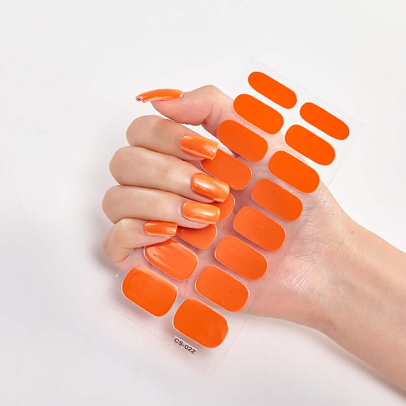 Pure Color 16 nail stickers in vibrant orange, displayed on a hand with matching manicure.