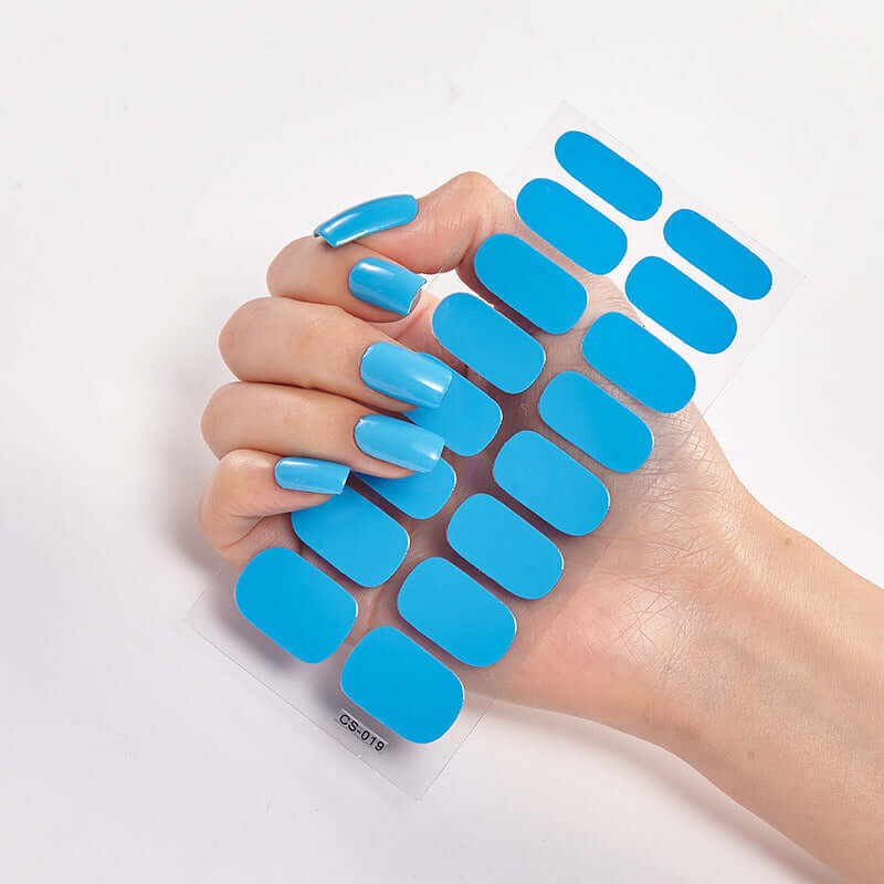 Blue Pure Color 16 Nail Stickers displayed on a hand with matching blue nails, showcasing vibrant color options.