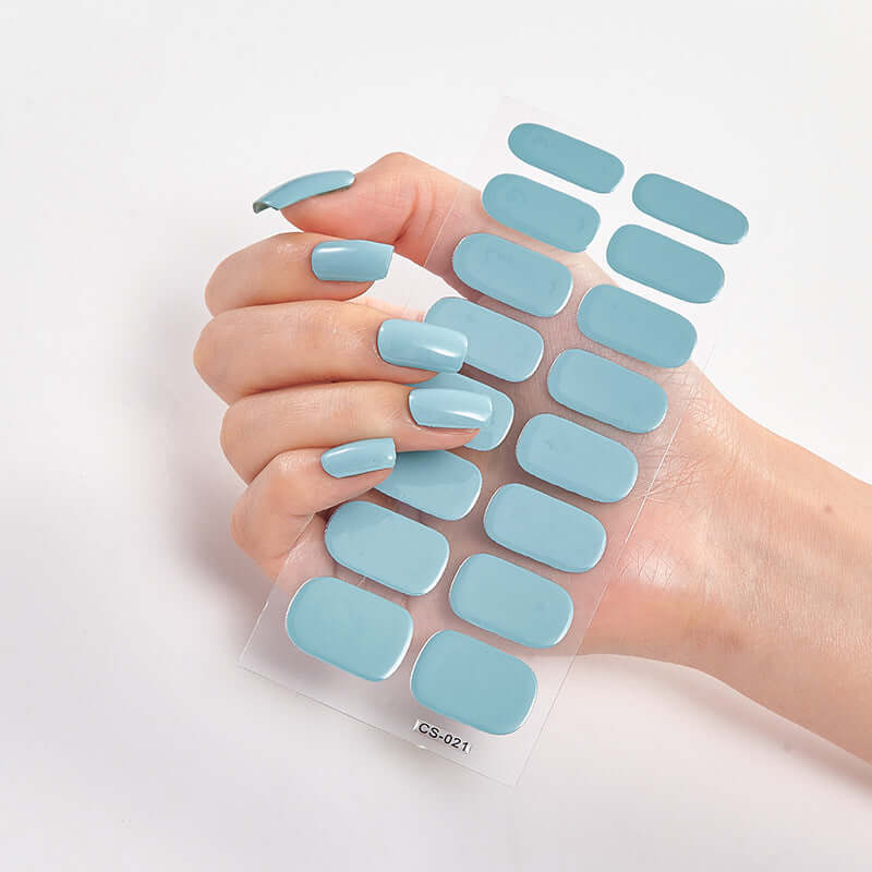 Pure Color 16 Nail Stickers in solid blue, showcasing hand with elegant long nails and sticker sheet.
