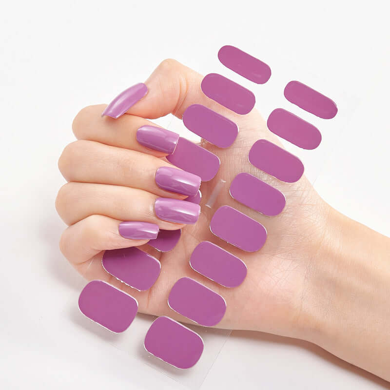 Hand displaying purple Pure Color Nail Stickers alongside glossy purple nails for nail art inspiration.