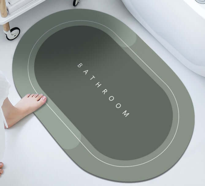 Modern oval bathroom mat with gray color, featuring 'BATHROOM' text, designed for absorbency and quick-drying.