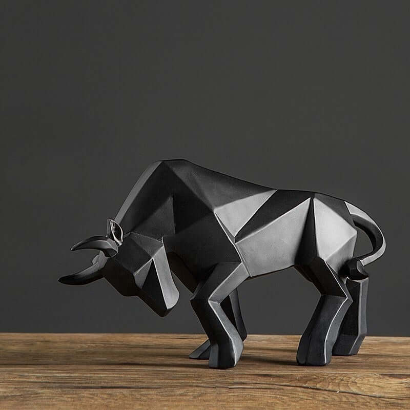 Geometric black resin bull sculpture on a wooden table, modern home decor piece.