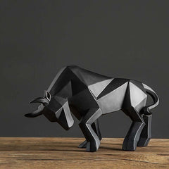 Geometric black resin bull sculpture on a wooden table, modern home decor piece.