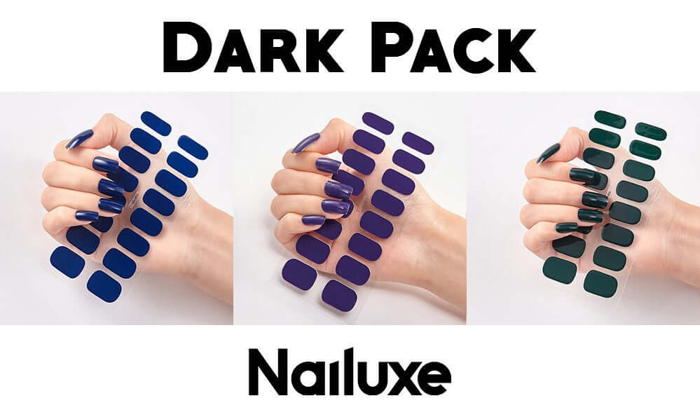 Dark Pack Nailuxe with a hand showing multiple nail stickers in dark blue, purple, and green shades.