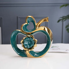  Stylish ceramic apple-shaped decorative piece with a glossy teal finish for modern living room decor.