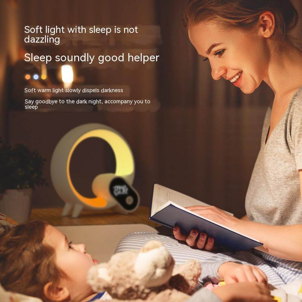 Mother reading to child with Creative Q Light Alarm Clock providing soft, warm light for a peaceful bedtime atmosphere.