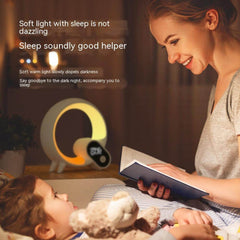 Mother reading to child with Creative Q Light Alarm Clock providing soft, warm light for a peaceful bedtime atmosphere.