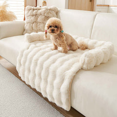 Cozy plush dog mat on a couch with a playful dog, perfect for winter warmth and comfort.