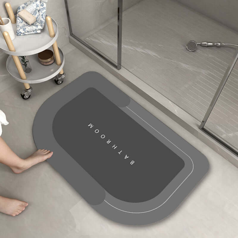 Modern oval bathroom mat in dark gray, absorbent and quick-drying for shower use, ideal for home decor.