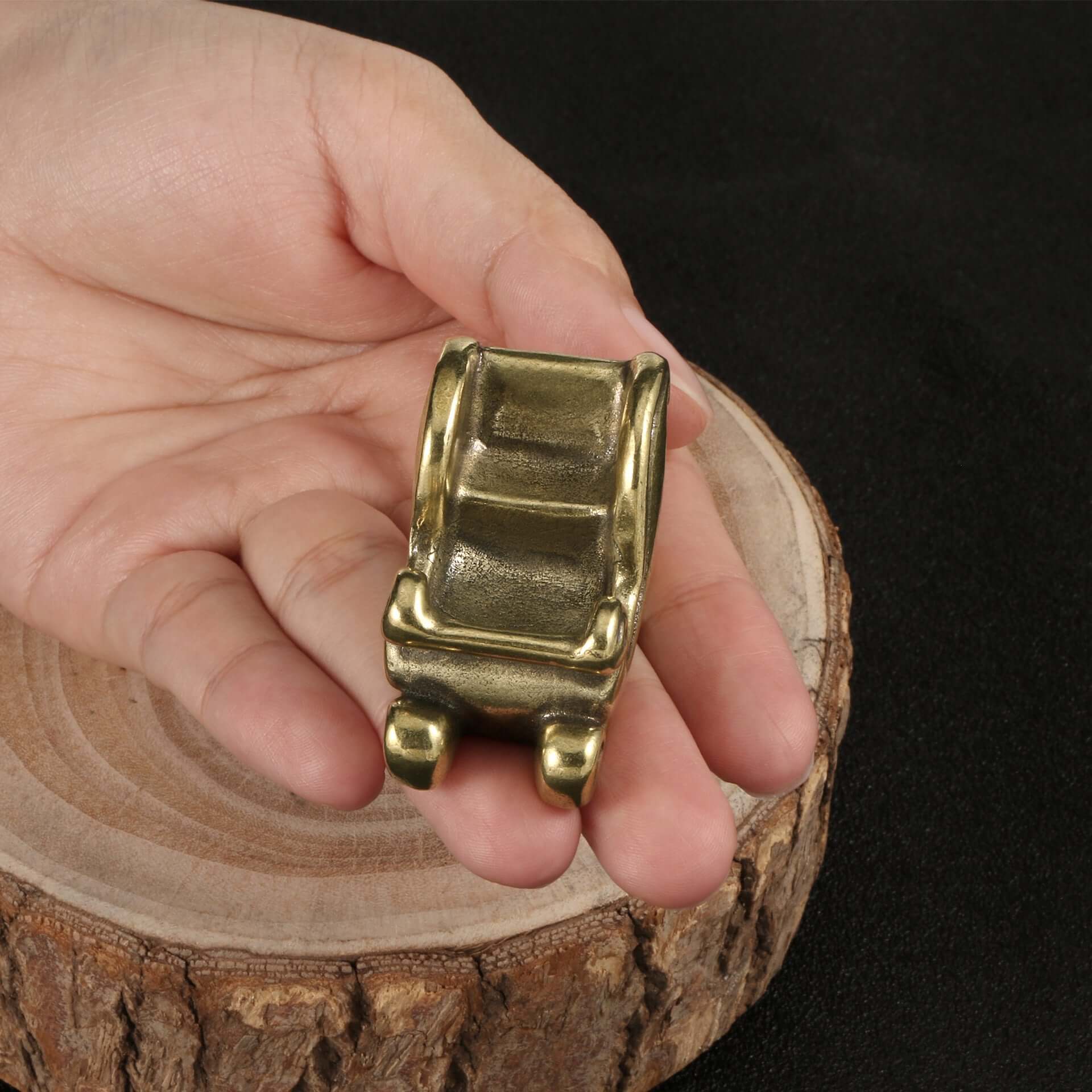 Antique brass Christmas sled ornament held in hand, perfect for holiday decoration and crafts.