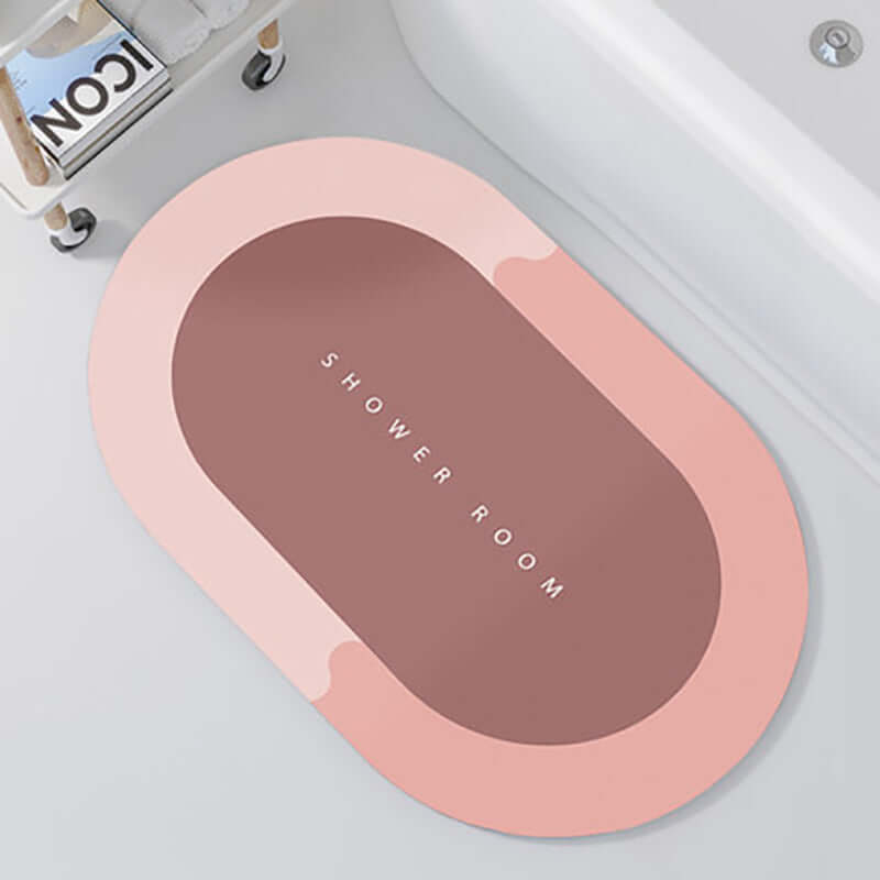 Oval shower room floor mat in soft pink with modern design, perfect for absorbing water and quick-drying.