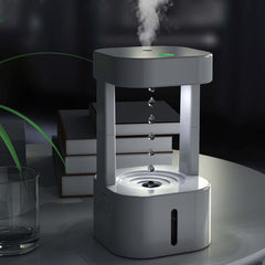 Creative anti-gravity humidifier with mist spray, showcasing water droplets flowing upward in a stylish design.