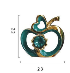  Stylish ceramic apple-shaped decorative piece with a glossy teal finish for modern living room decor.