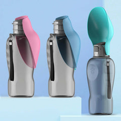 Portable dog water bottles with foldable bowls in pink and blue for outdoor pet hydration.