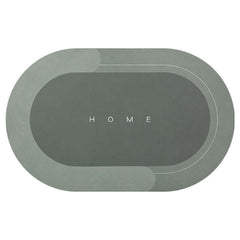 Oval modern bathroom mat in elegant gray with 'HOME' text, quick-drying and absorbent for home use.