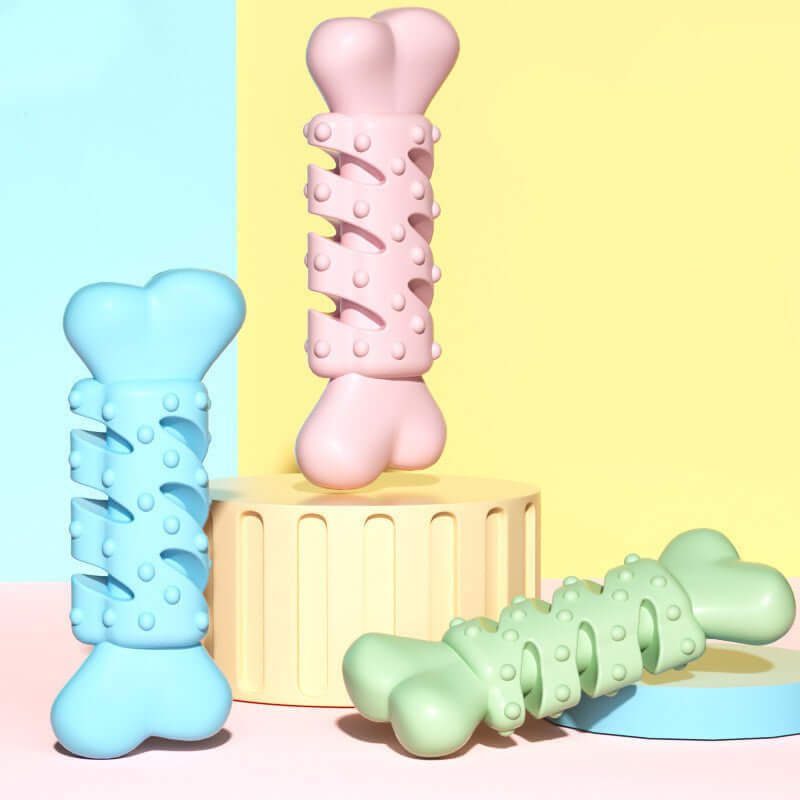 Colorful dog bone-shaped teething toys in blue, pink, and green, designed for chewing and teething comfort.
