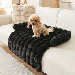Cozy black plush dog mat on a sofa, perfect for winter warmth and comfort for small pets.