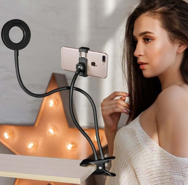 Lady using LED selfie ring light with smartphone clamp for adjustable makeup lighting