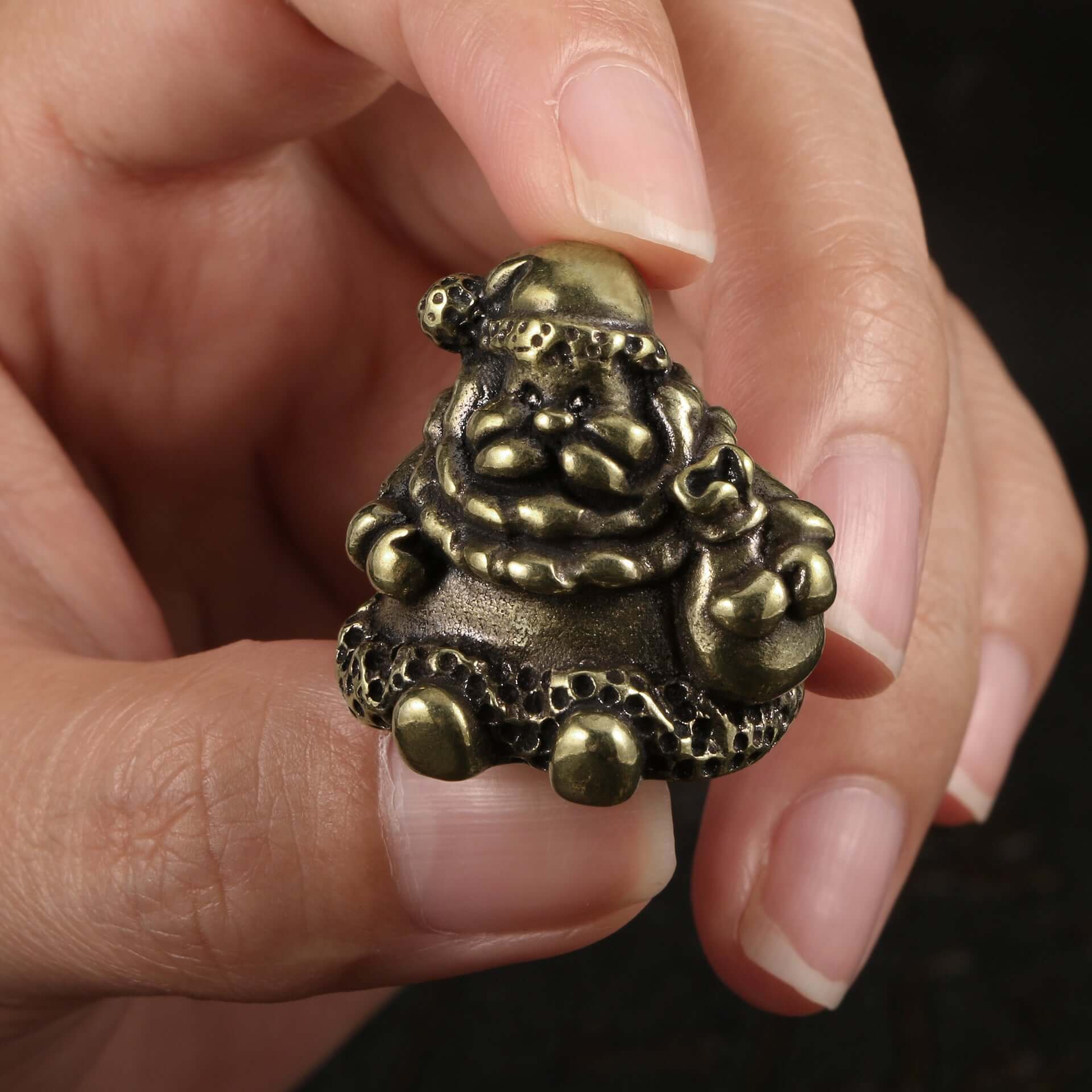 Brass Christmas sled figurine held by hand, showcasing antique design and festive detail for holiday decor.