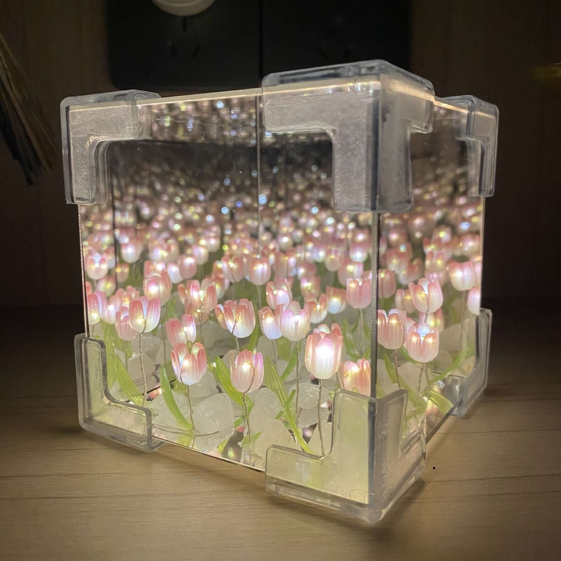 Handmade DIY tulip night light reflecting soft pink flowers in a stylish mirror cube decoration.