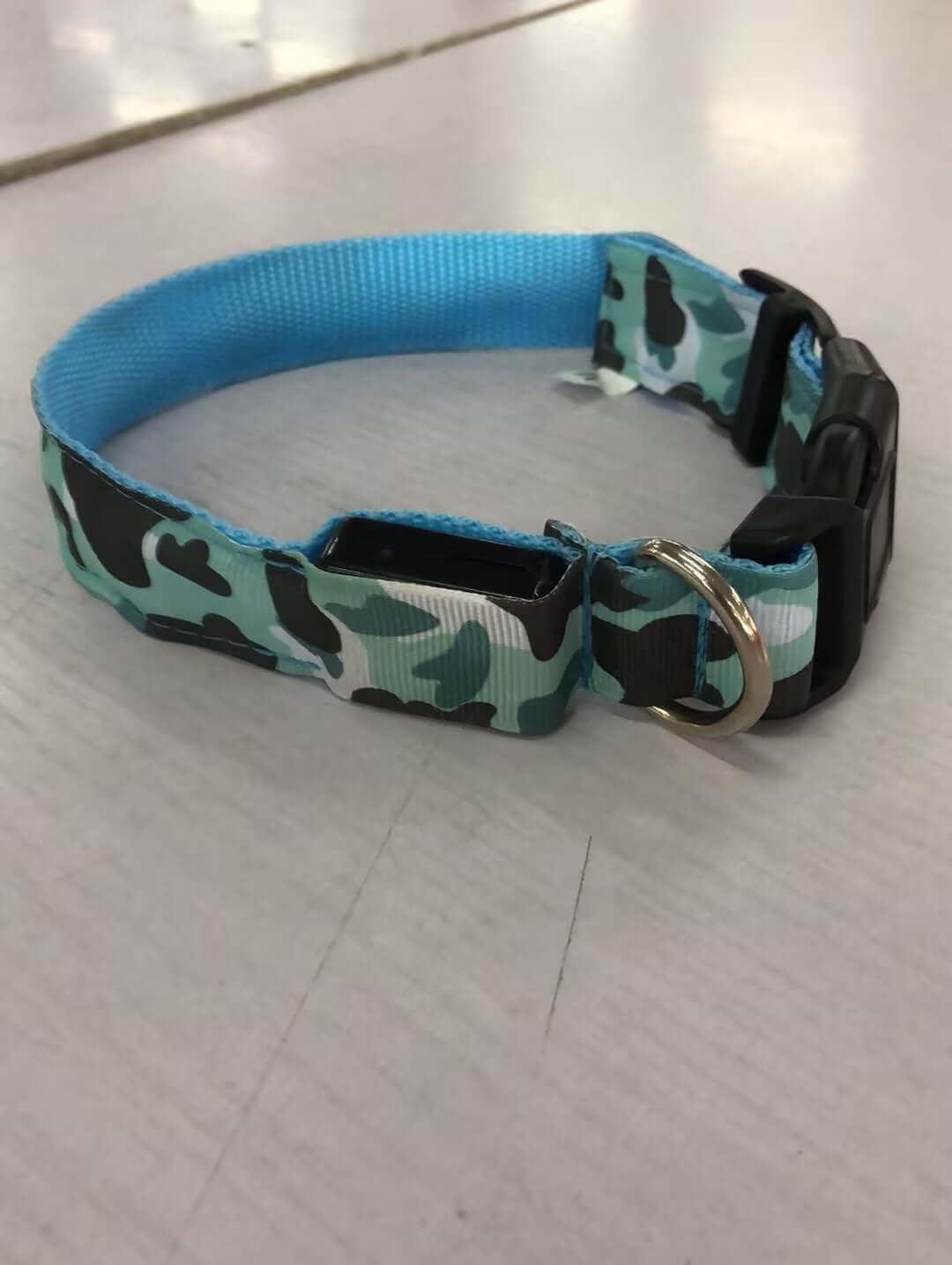 Camouflage luminous dog collar made of durable nylon, featuring plastic buckle and adjustable design for pets.