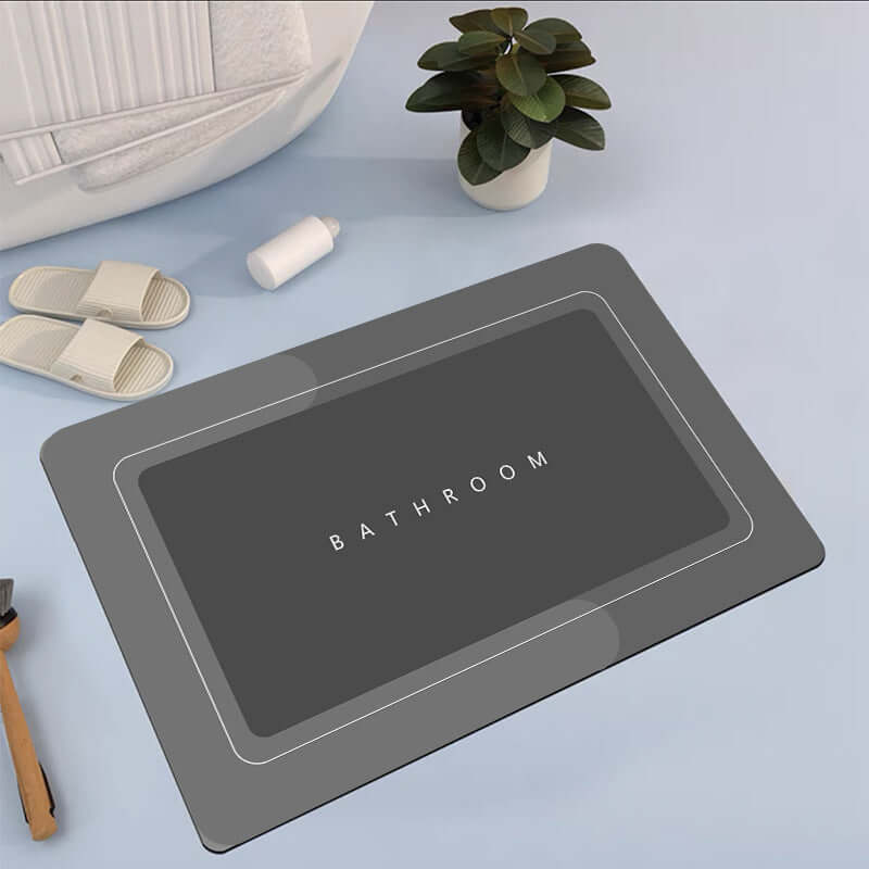 Modern bathroom mat in dark gray with 'BATHROOM' text, ideal for absorbent and quick-drying needs.