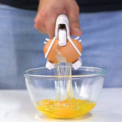 Handheld plastic egg cracker breaking eggs into a bowl, showcasing an egg separator kitchen gadget in action.