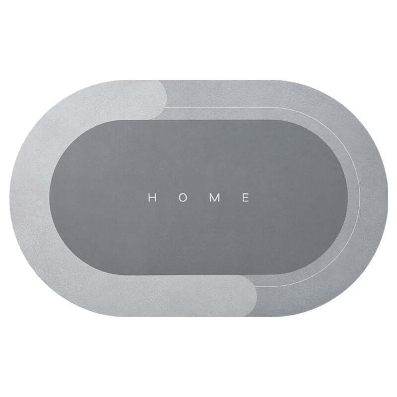 Modern oval bathroom mat in elegant gray, featuring 'HOME' text, absorbent and quick-drying for home use.