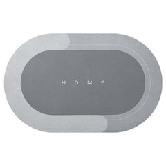Modern oval bathroom mat in elegant gray, featuring 'HOME' text, absorbent and quick-drying for home use.