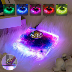 Levitating UFO Galaxy Lamp with color-changing lights on a fuzzy surface, creating a cosmic ambiance.