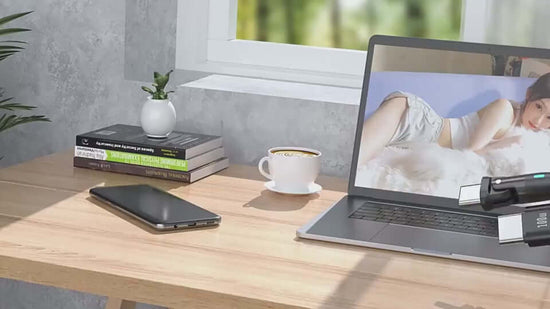 Modern workspace featuring a laptop, mobile phone, coffee cup, and books on a desk with natural light.