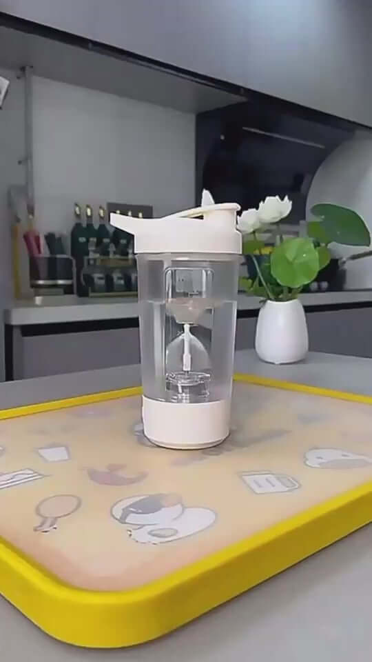 400ml electric protein powder mixing cup on a yellow tray, designed for hassle-free blending with a sleek automatic design.