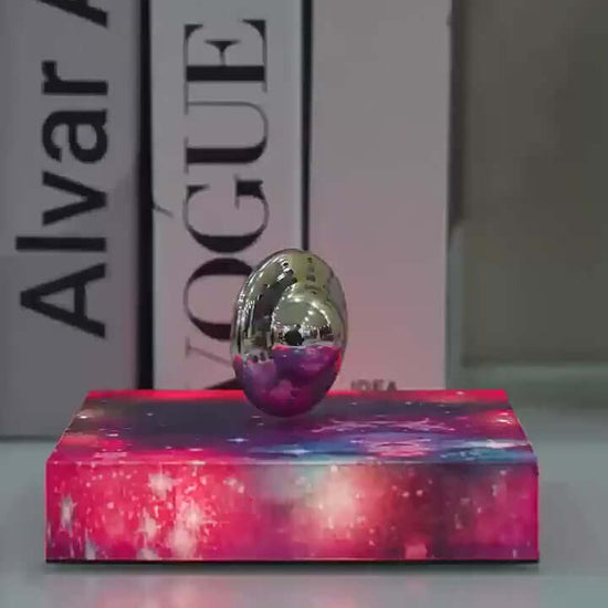 Levitating UFO galaxy lamp on a colorful base, creating a celestial ambiance in stylish home decor.
