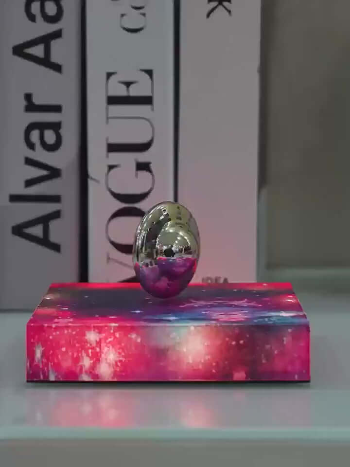 Levitating UFO galaxy lamp on a colorful base, creating a celestial ambiance in stylish home decor.