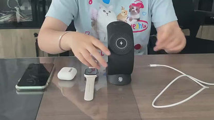 Person demonstrating a 4-in-1 magnetic wireless charger with phone, AirPods, and Apple Watch on a desk.