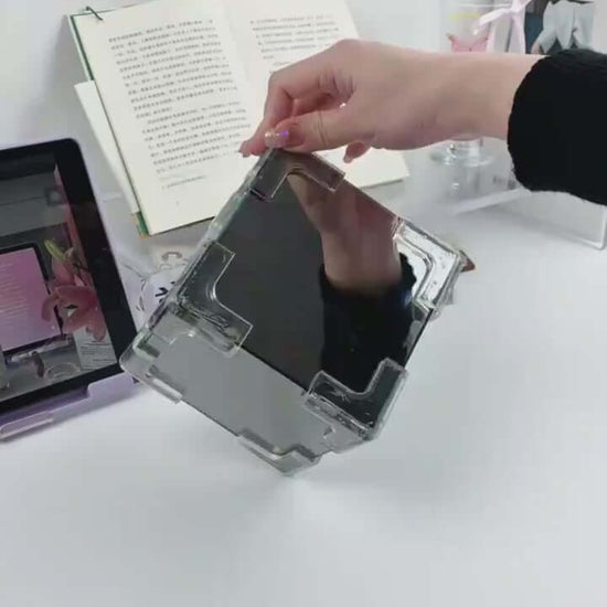 Hand holding a transparent DIY material pack for creating a tulip night light, showcasing its sleek design and functionality.