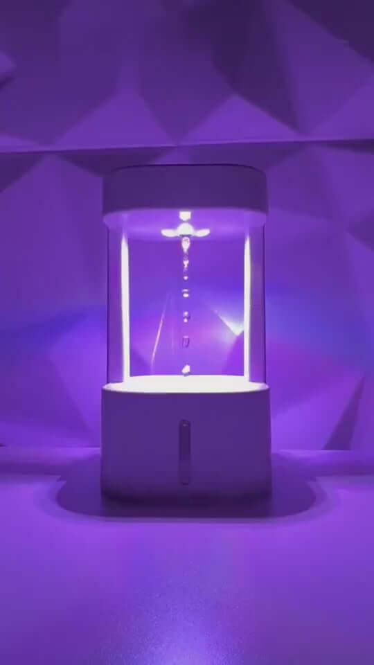 Anti-gravity humidifier with colorful lighting and mist spray, ideal for home or office use.